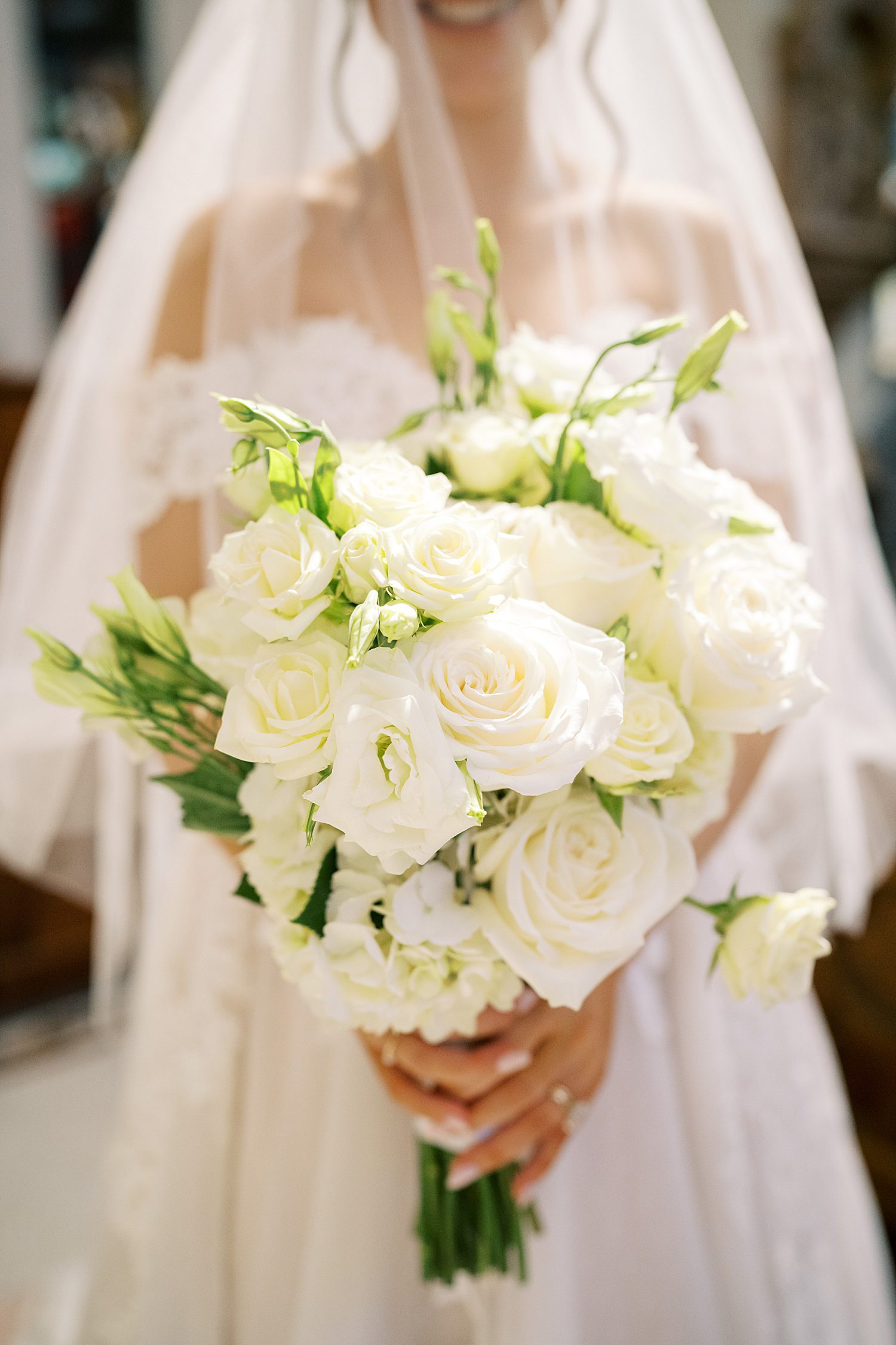 bride holding white rose bridal bouquet 