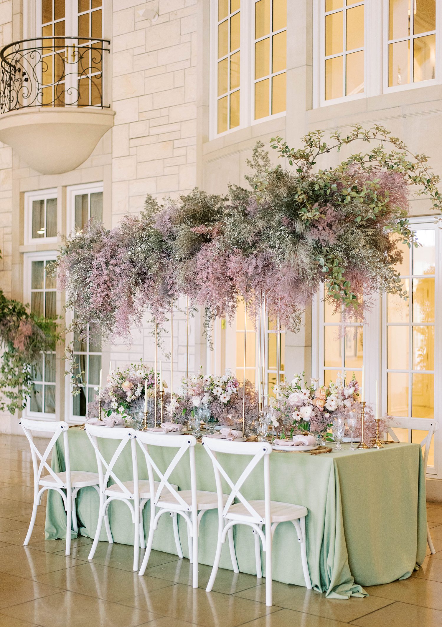 organic floral display hanging above reception table 