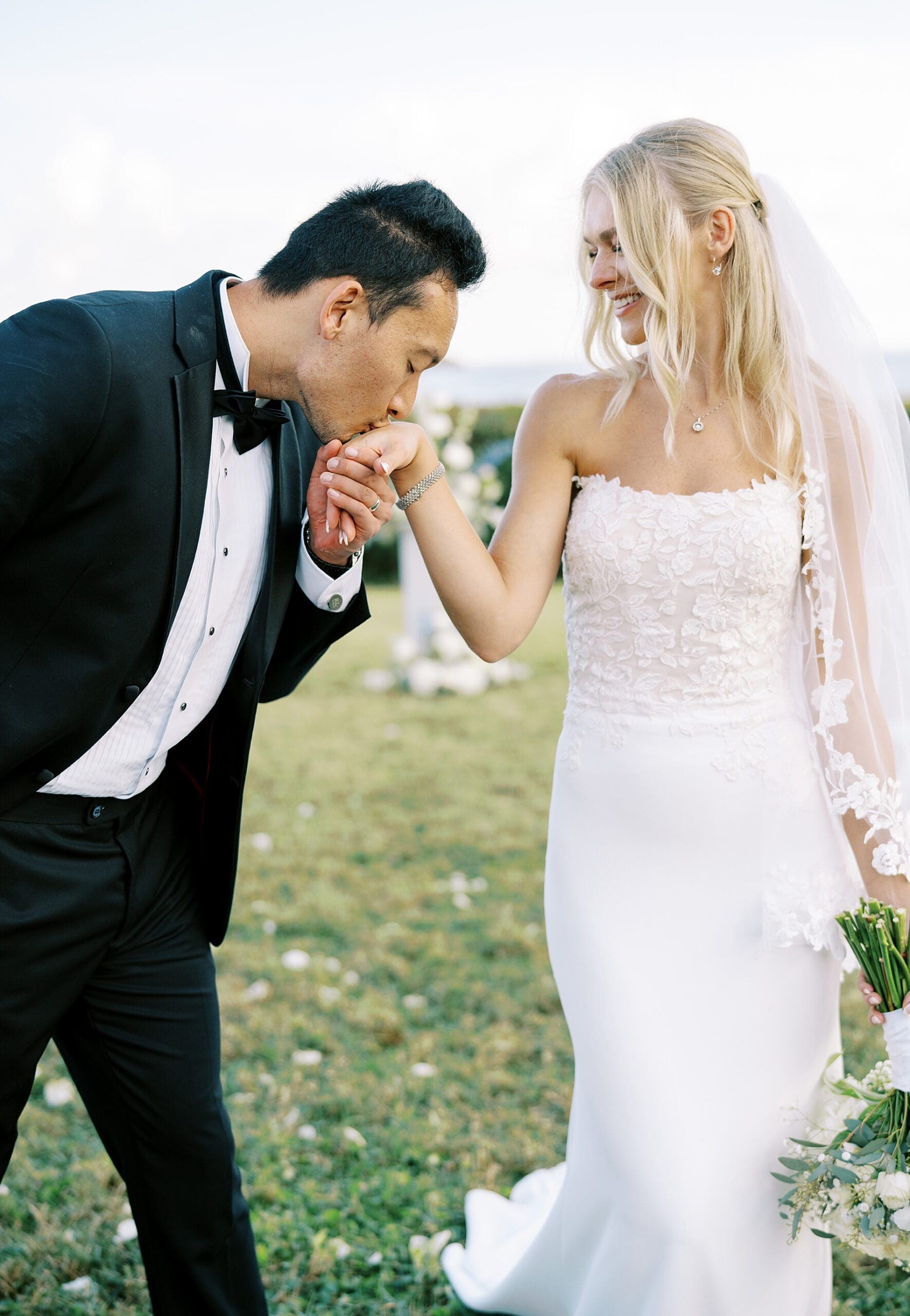 groom kisses bride's hand