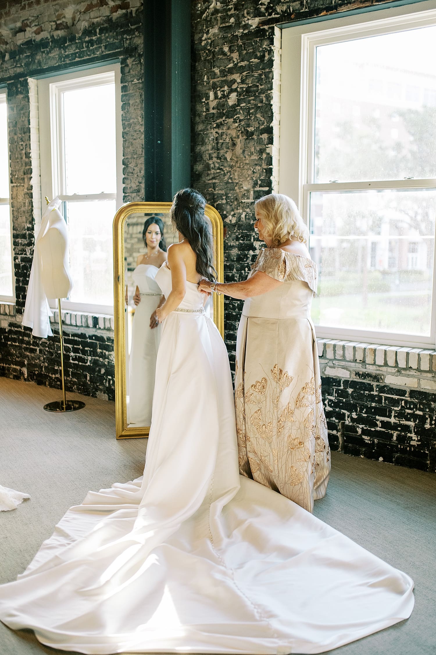 bride getting into wedding dress