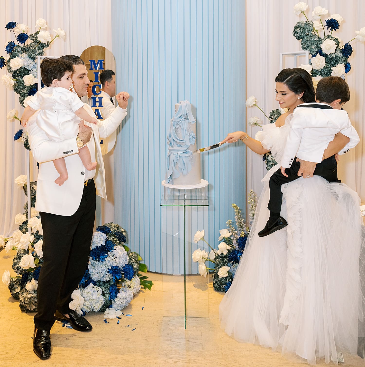 family cuts baptism cake