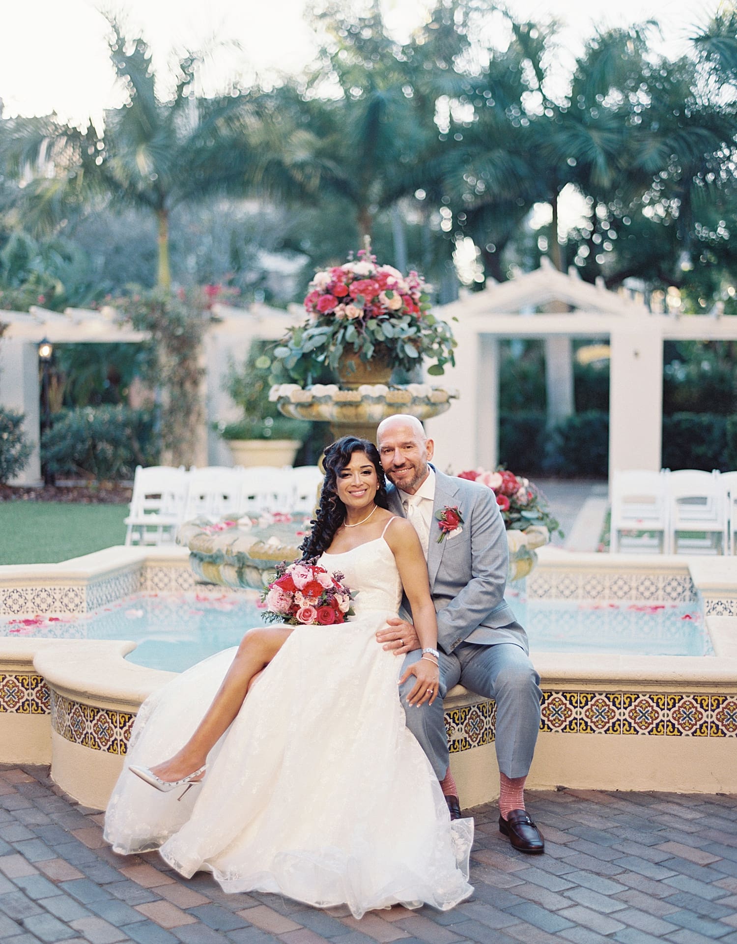 Romantic wedding portraits of newlyweds sitting by the Fountain at The Vinoy Resort