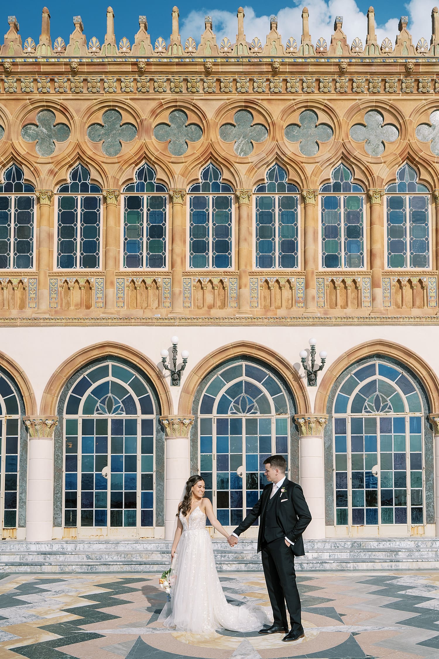 Bride and groom in front of gorgeous exterior of The Ringling Museum
