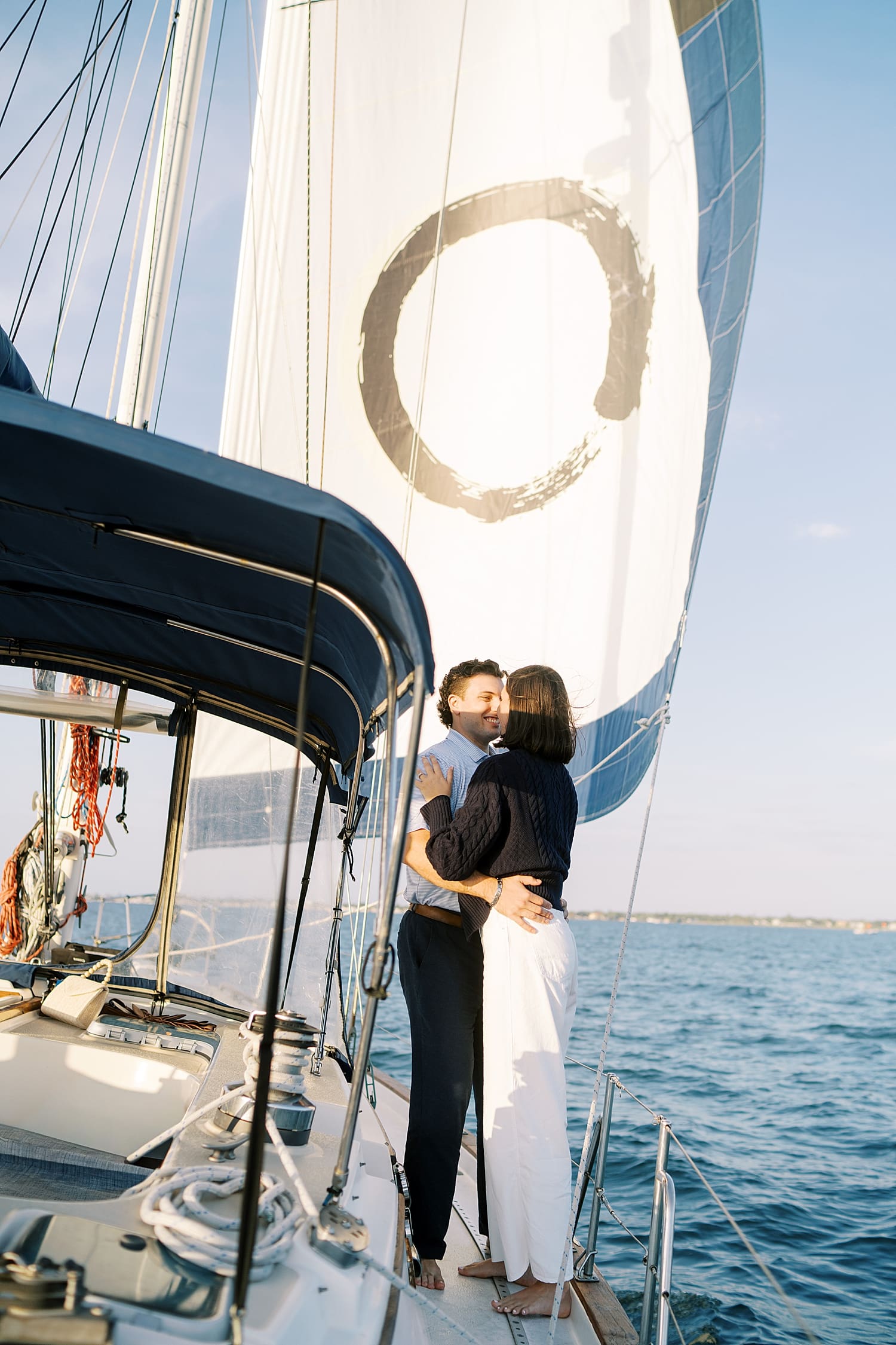 couple hugging on side of sailboat on the water in Tampa