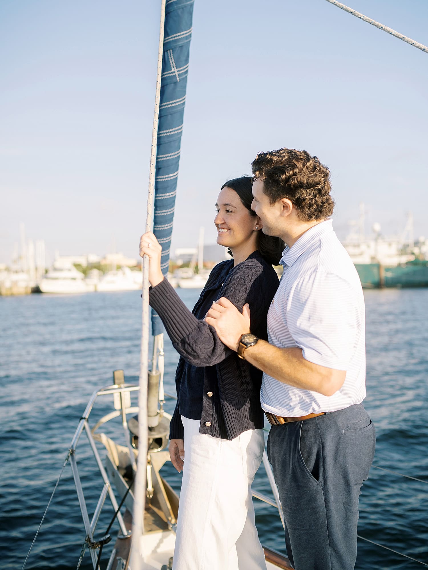 couple stand and look out over the water in Tampa, FL while on sailboat