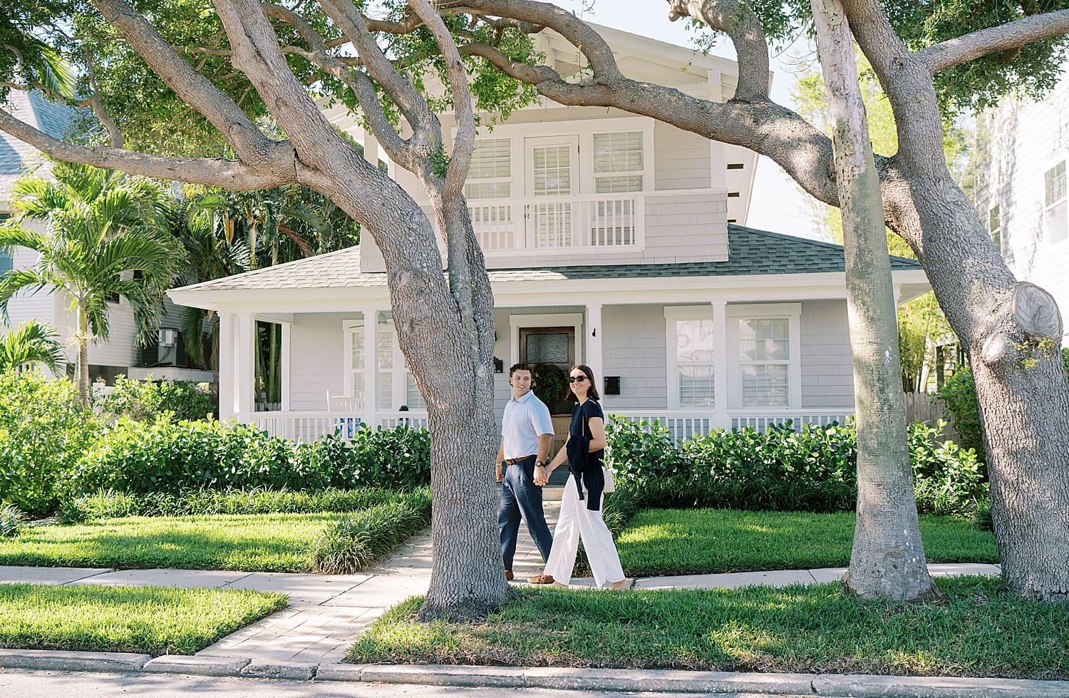 engaged couple walking through neighborhood