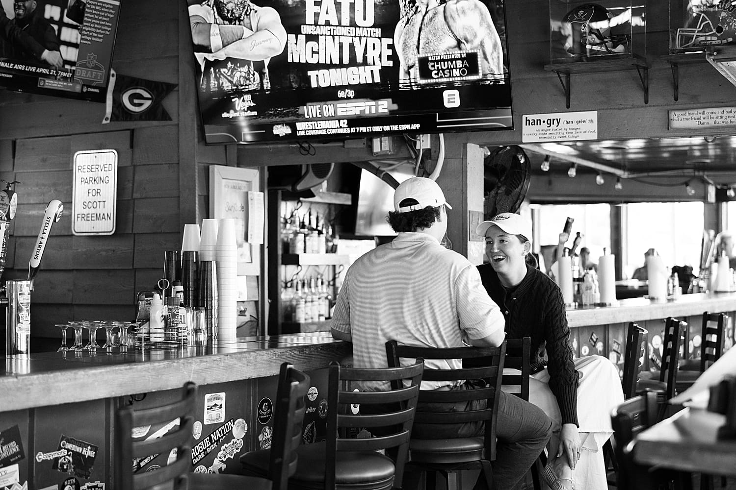candid engagement photo of couple in The Wharf Restaurant