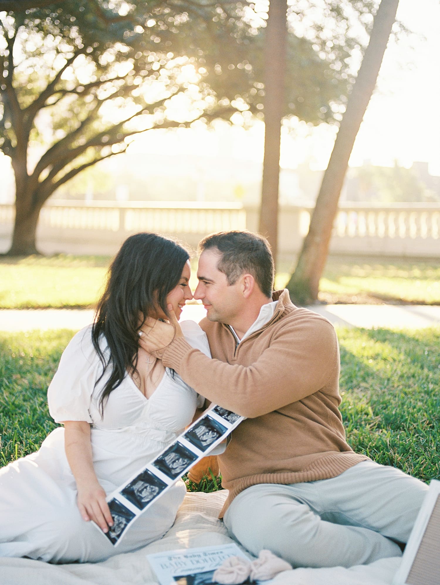 Maternity Session in Downtown Tampa at Curtis Hixon Park with couple holding ultrasound photos