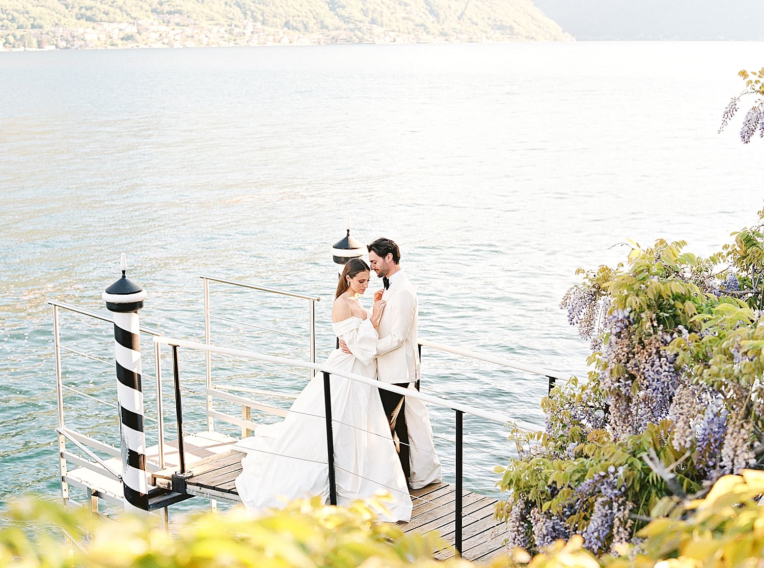newlyweds on private boat dock at Villa Balbiano