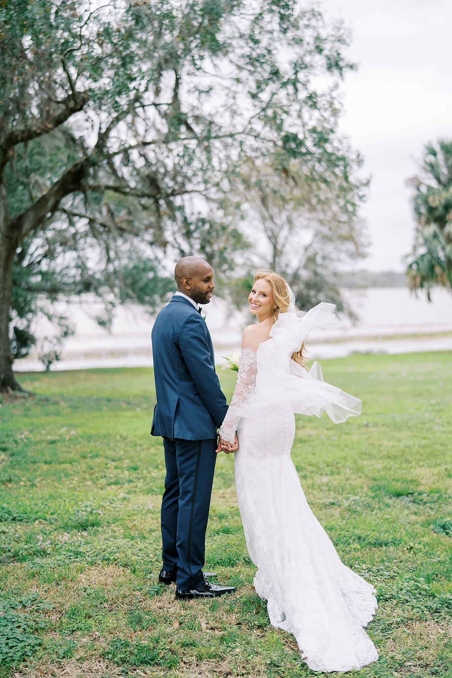 bride and groom portraits by the lake during first look