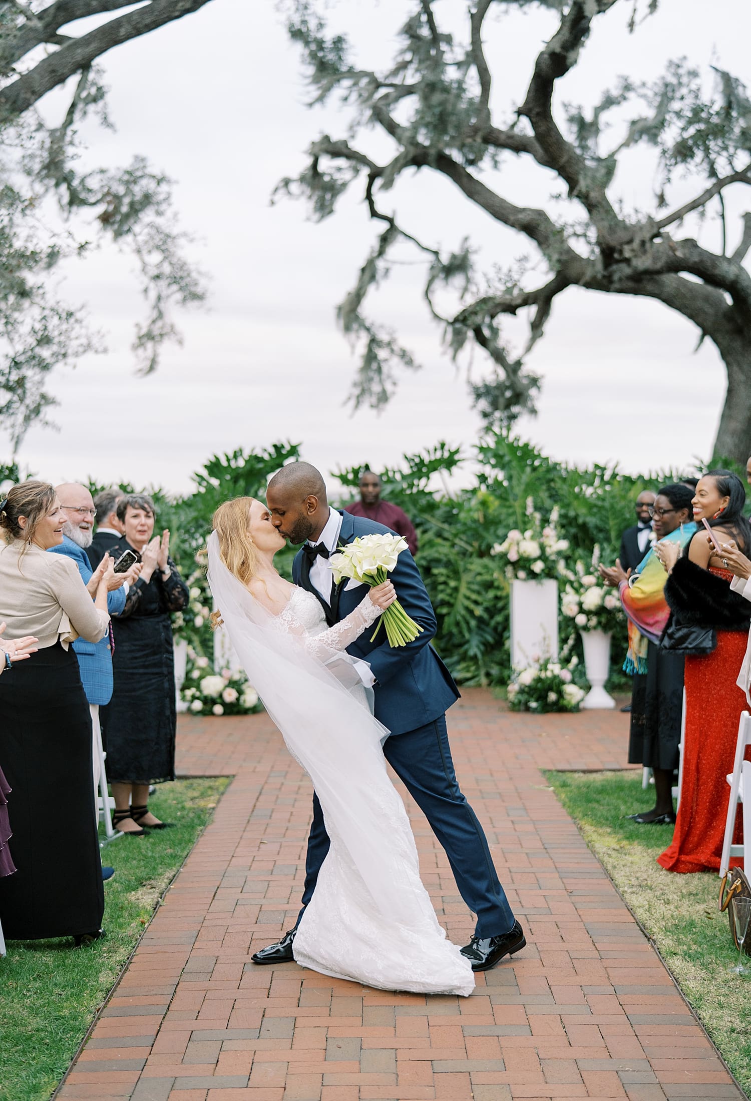 newlyweds kiss as they exit wedding ceremony