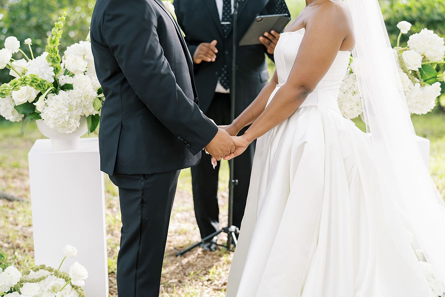 bride and groom hold hands