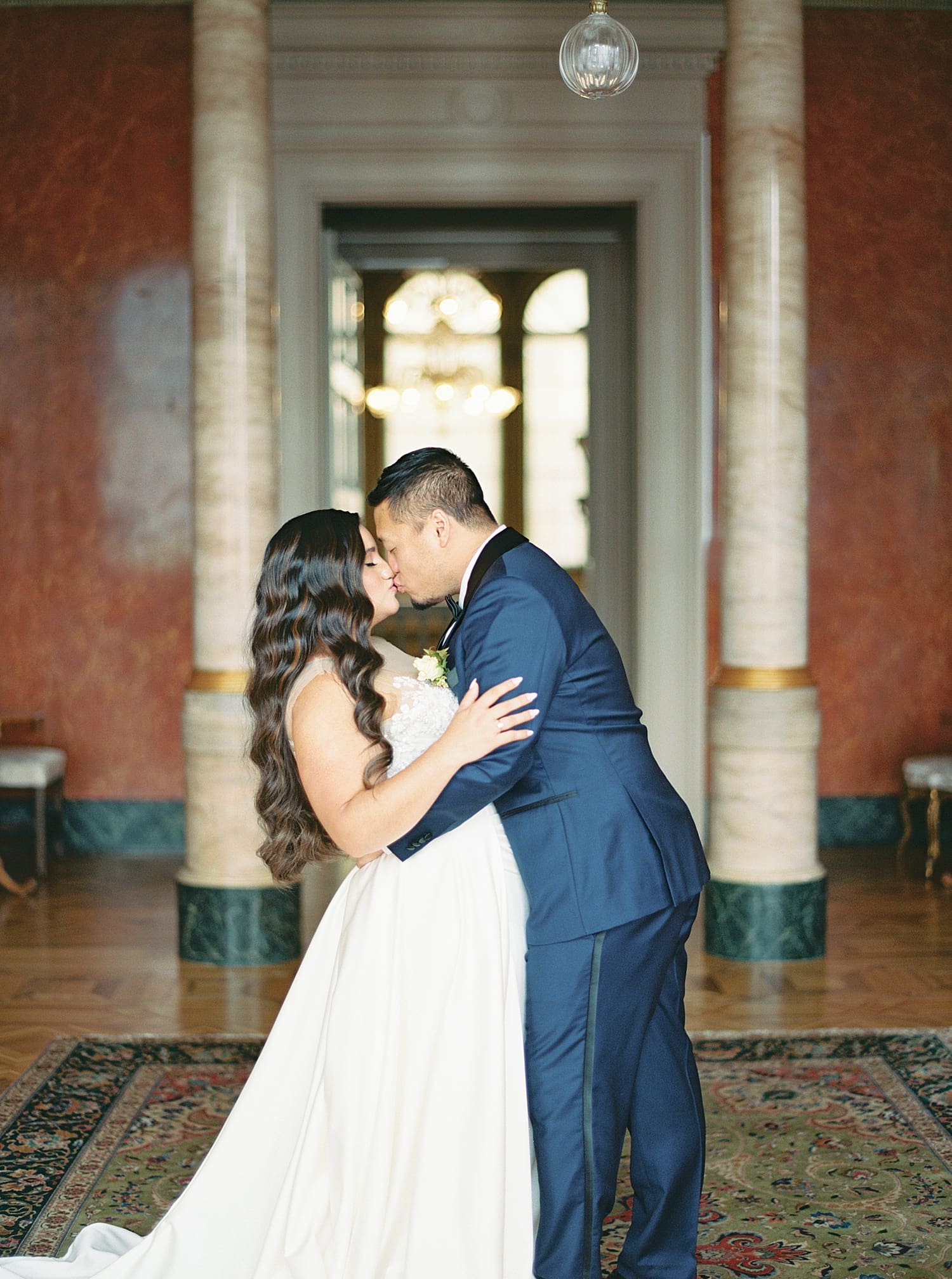 bride and groom kiss inside luxurious Grand Hotel Villa Serbelloni
