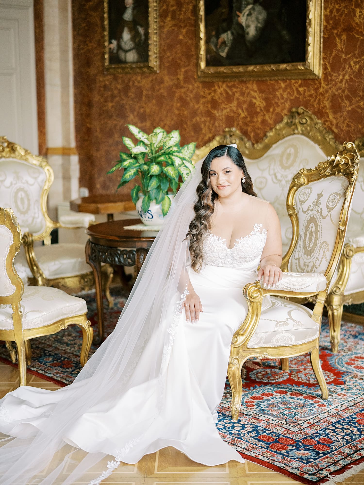 bride in elegant wedding dress sits in chair at Villa Serbelloni Wedding