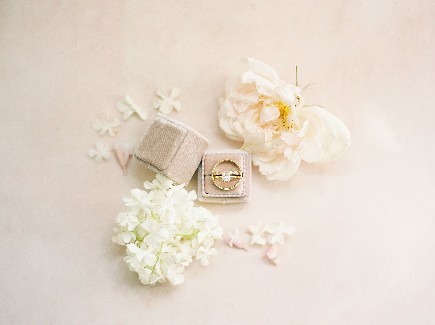wedding rings and flowers in flat lay image