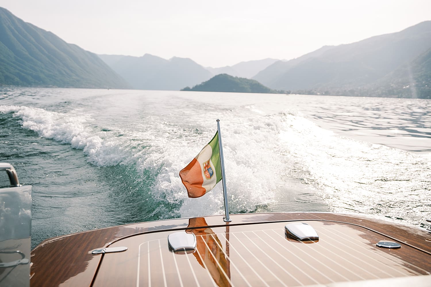 wedding couple take private boat ride on Lake Como to get to Villa del Balbianello Wedding