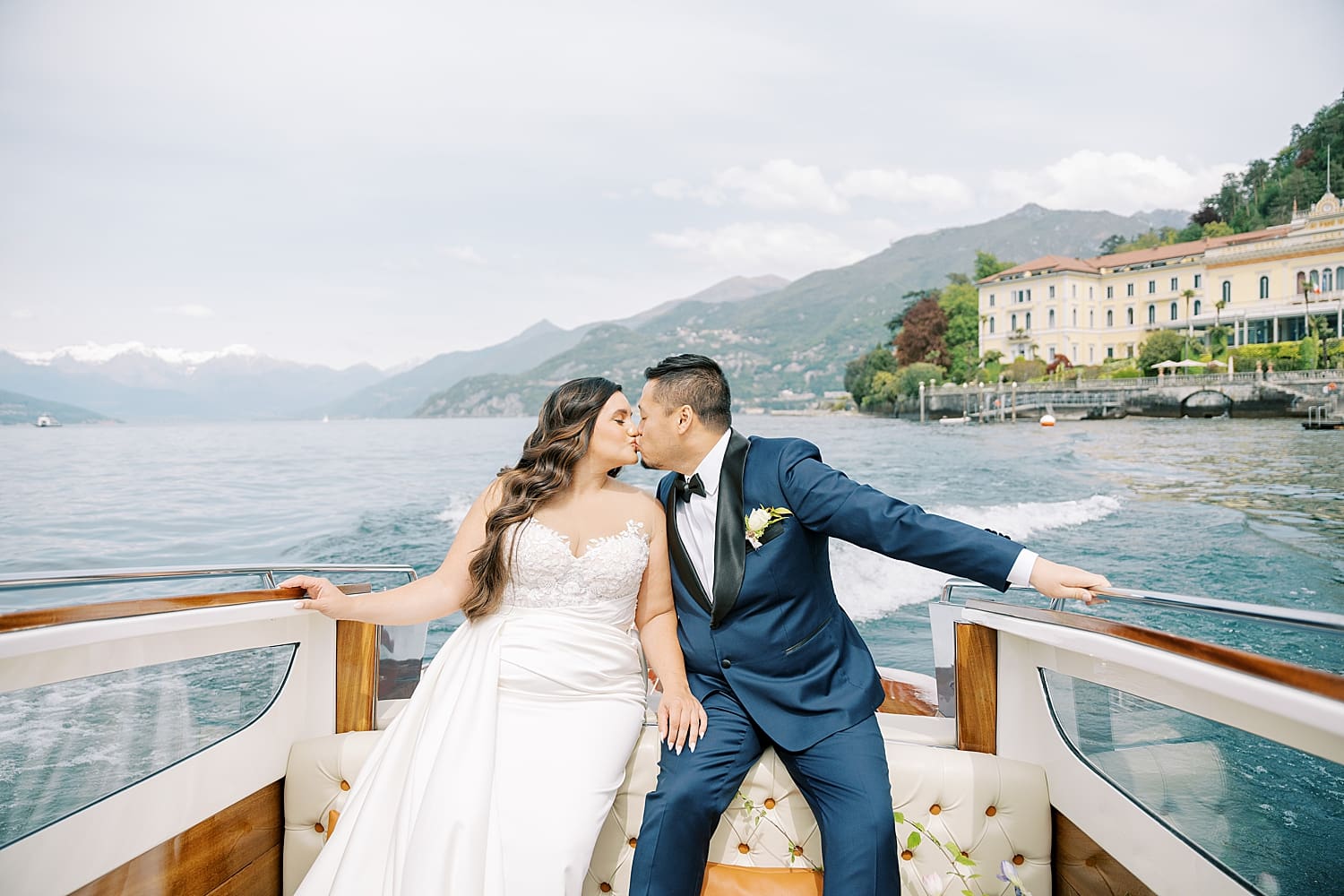 bride and groom kiss on boat in Lake Como