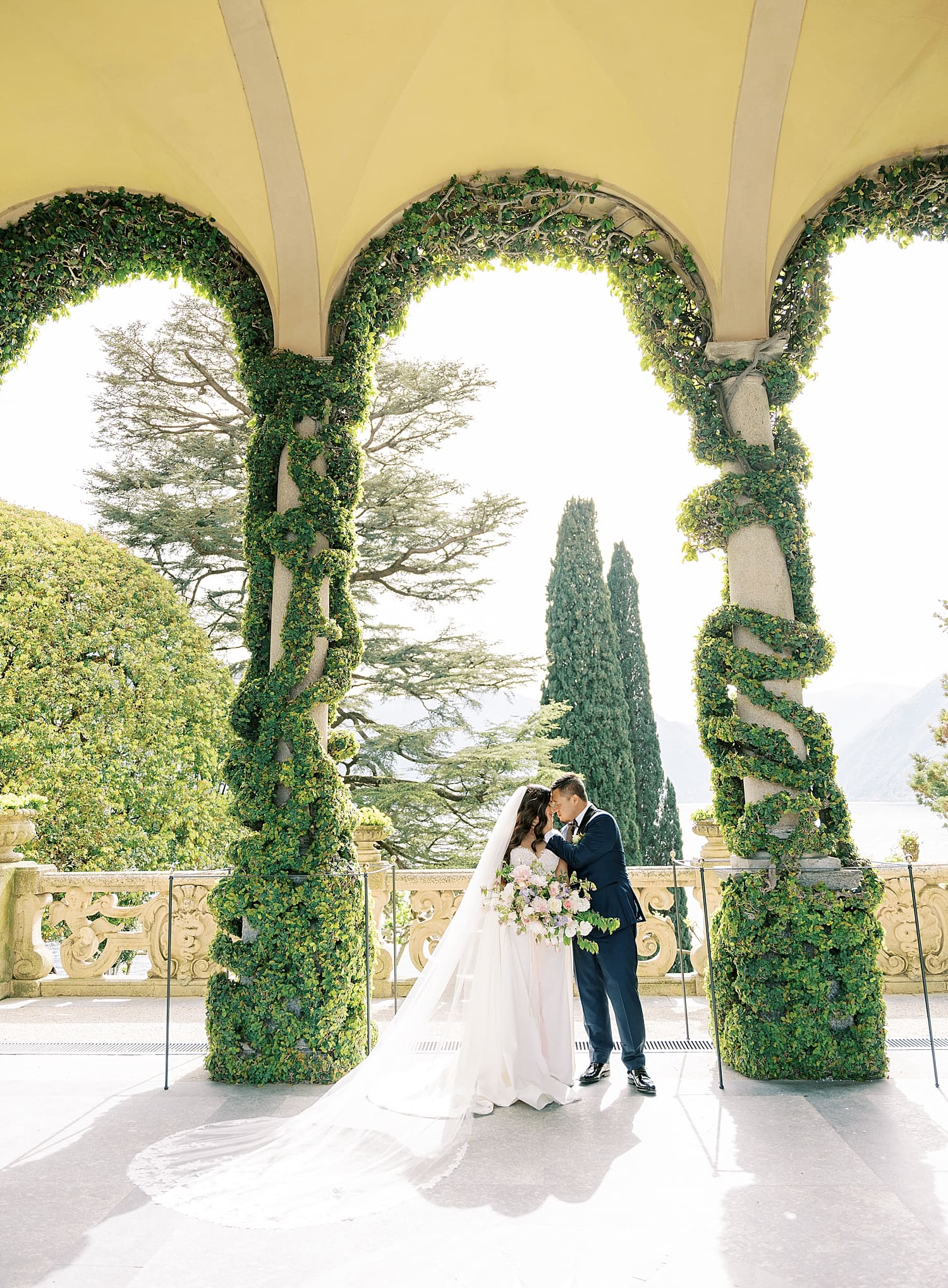 Couple kiss at Romantic and luxurious wedding venue, Villa del Balbianello on Lake Como