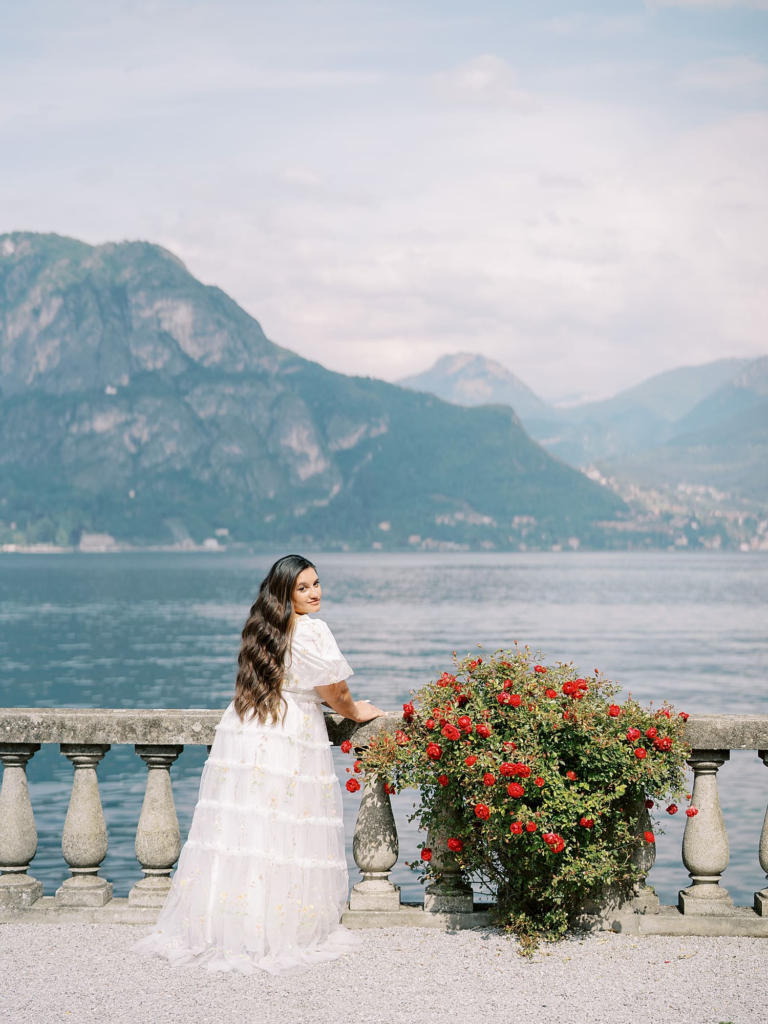 Villa Serbelloni photoshoot with woman on balcony and mountains in the distance of Lake Como